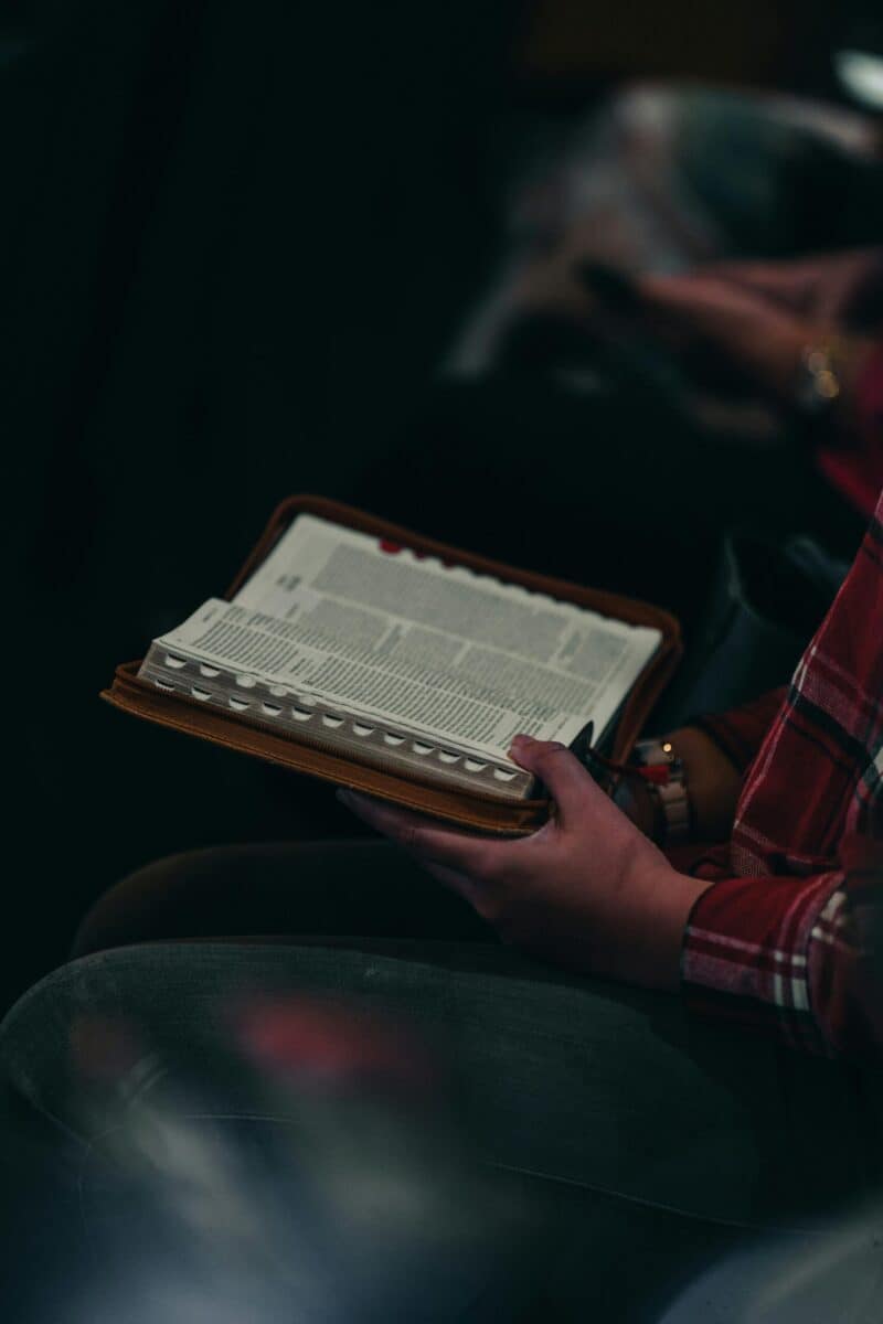 Close-up image of a person reading an open Bible. Captured in Jakarta, Indonesia.
